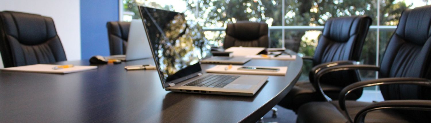 boardroom with chairs and laptop