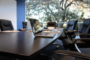 boardroom with chairs and laptop